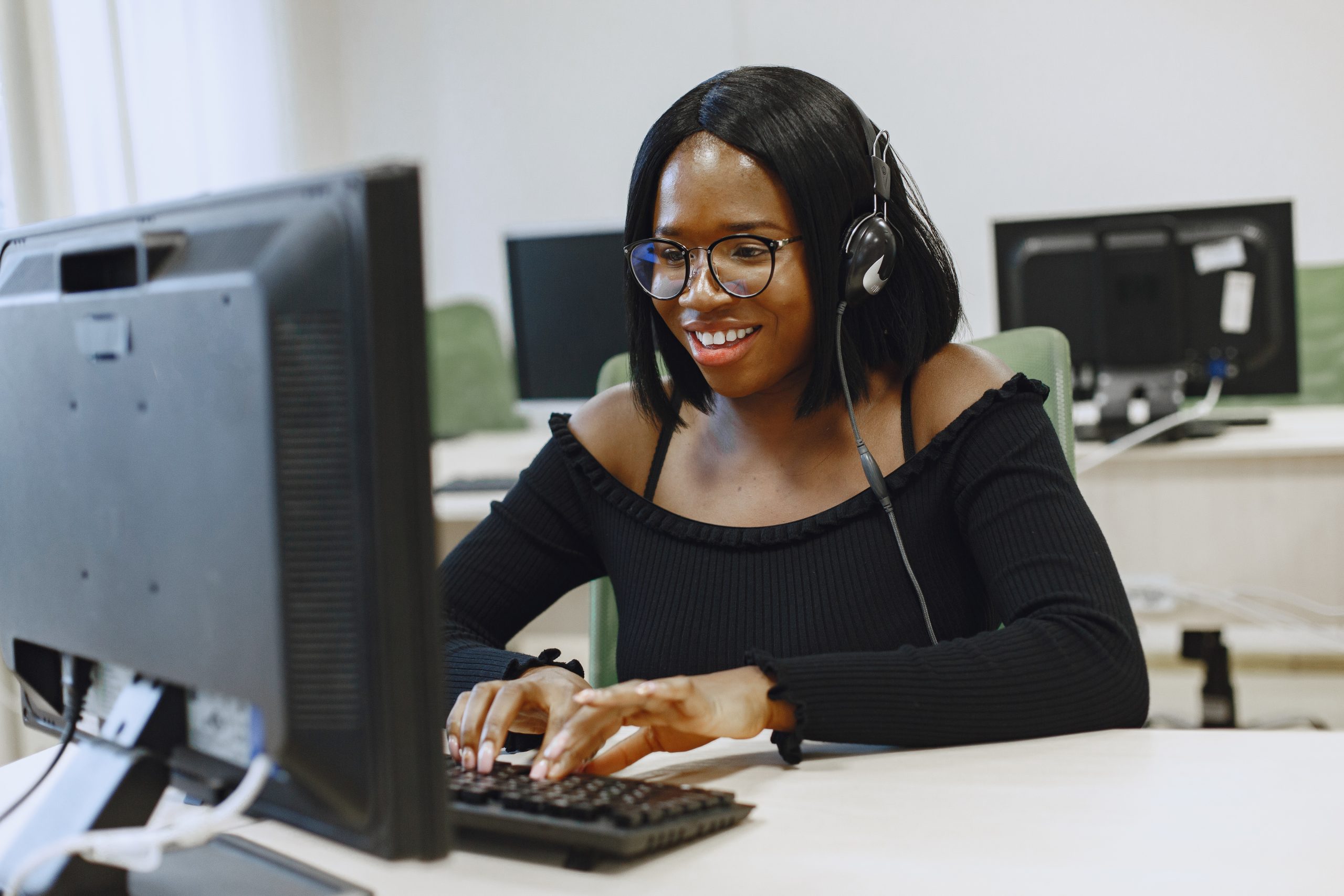 young lady working at computer wth glasses on